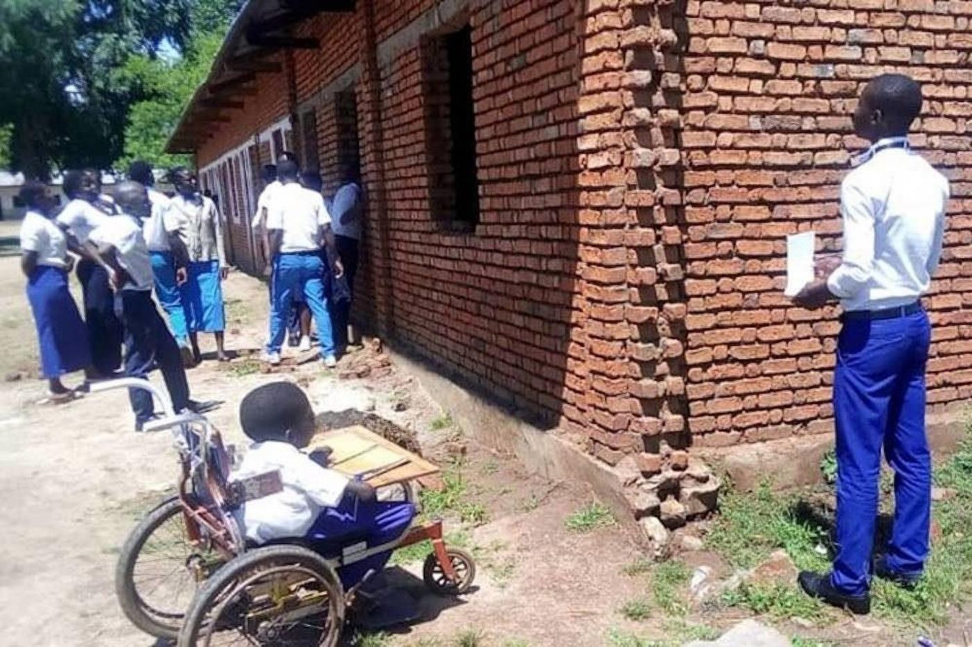 Community monitors inspect a school building in Luvungi